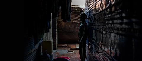 Child standing in alley