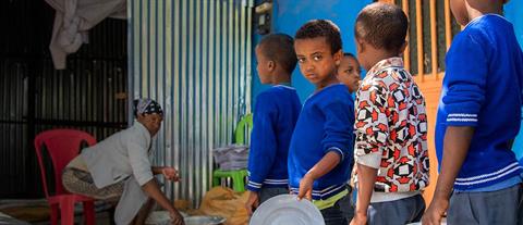 Several children in a food line in Ethiopia, Africa