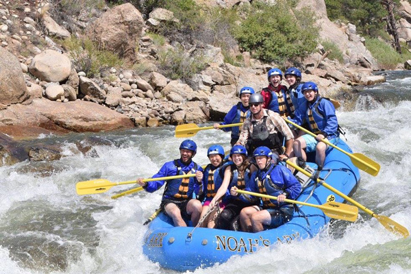 A group of interns white water rafting