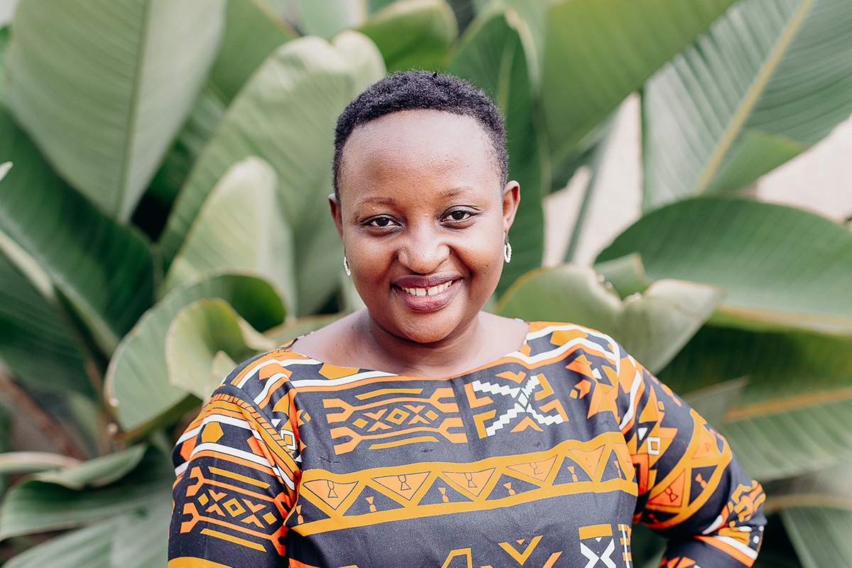 Justine smiles wearing a printed shirt