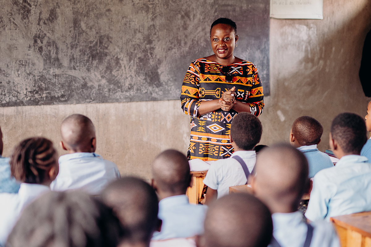Justine stands in front of a classroom as she interacts with the students in the classroom
