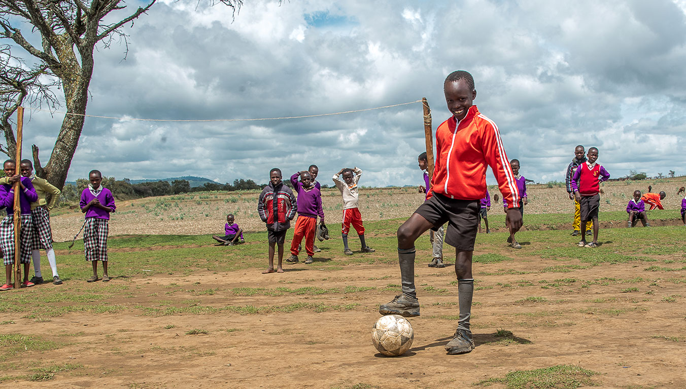 Children playing soccer at a Compassion Center
