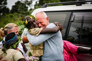 a Compassion child hugs her sponsor