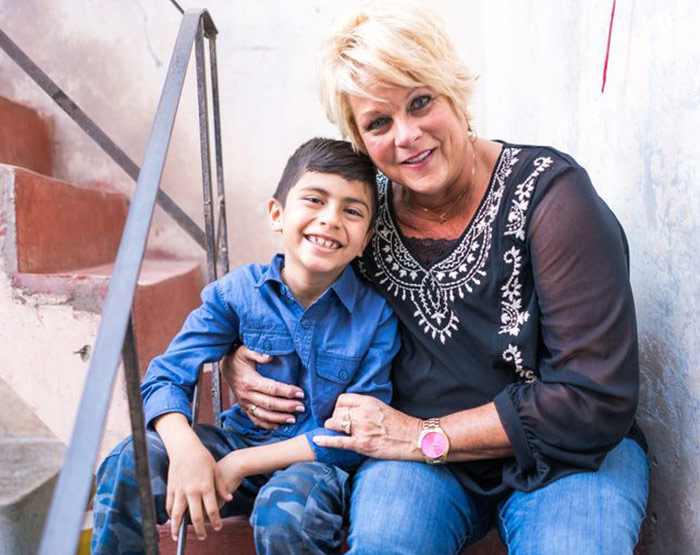 Betsy Langmade of Lifeway smiles with a young boy