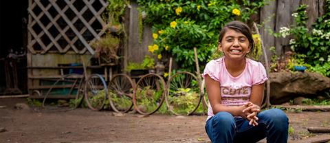 a young girl sitting on the ground