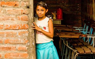 A girl standing in the doorway of her classroom