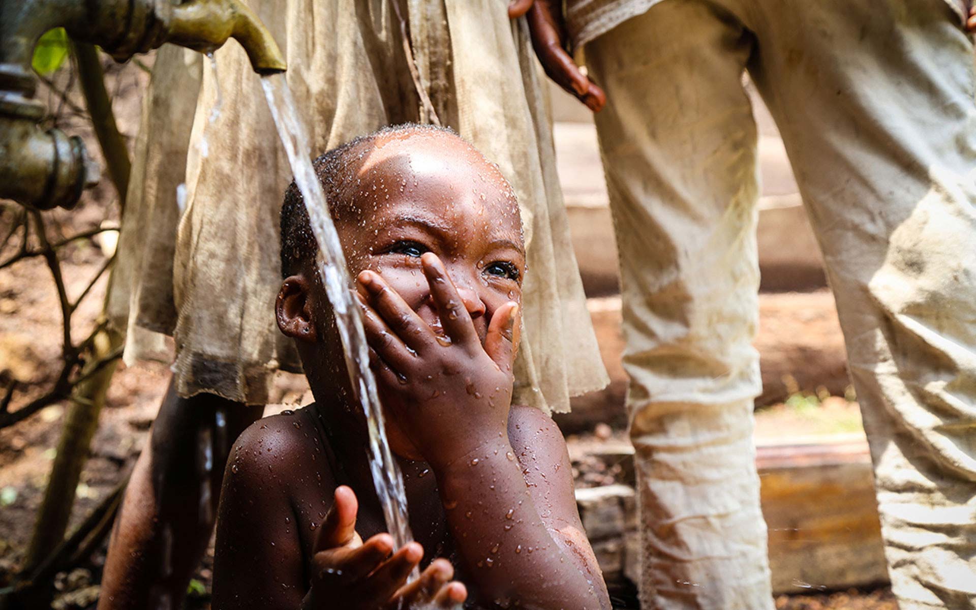 A young boy drinking clean water