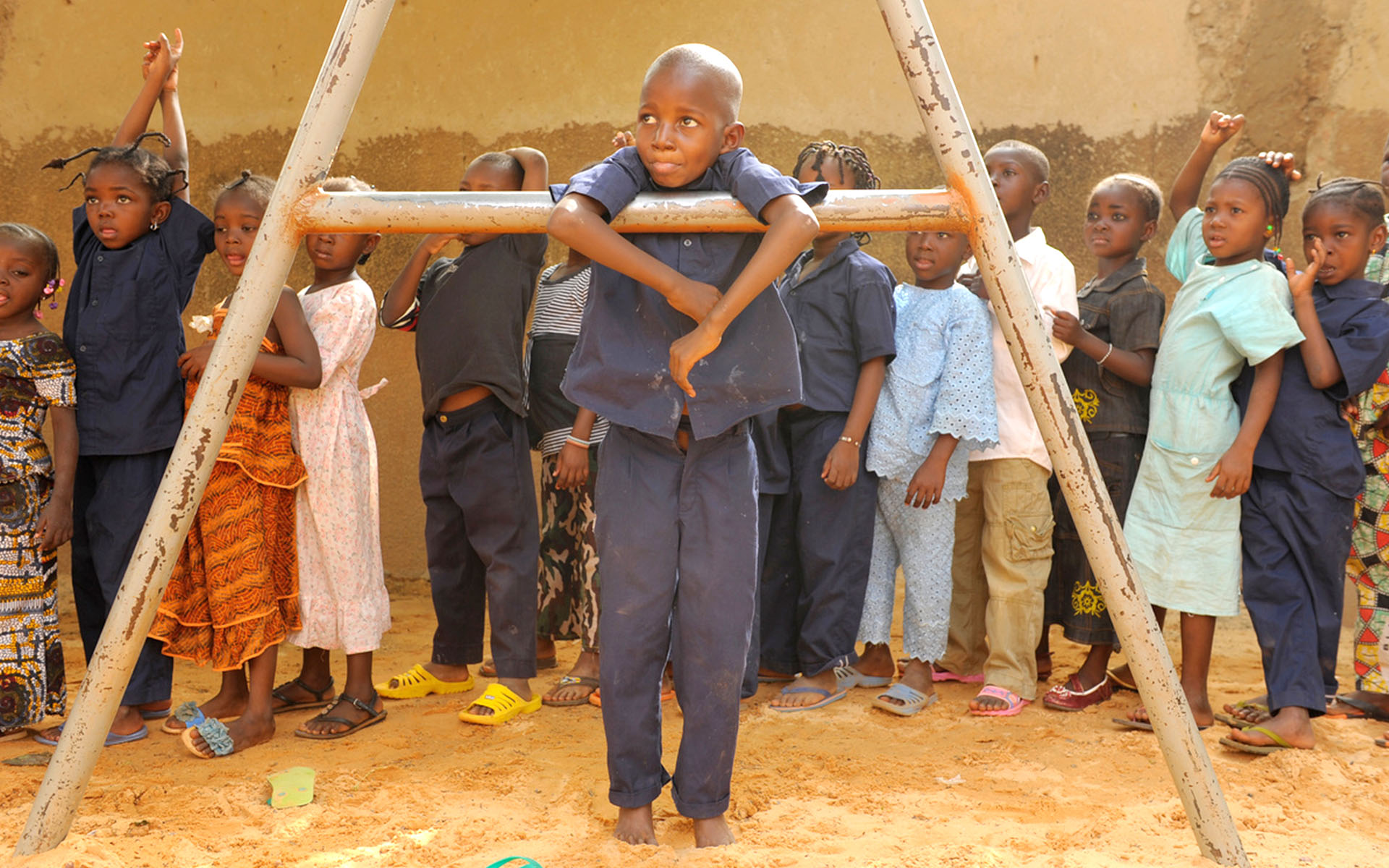 A boy plays on a swingset at his Compassion center