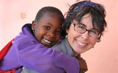 Sponsor Pammi Simone spends time with a sponsored child in Tanzania