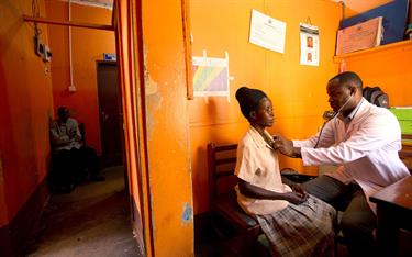 A mother with HIV having a checkup from a doctor in Uganda