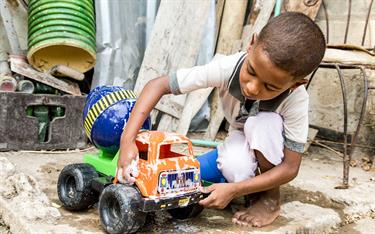 A sponsored boy in Columbia plays with the truck he received for Christmas