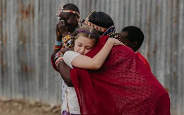 A girl hugs the mother of a Kenyan sponsored child