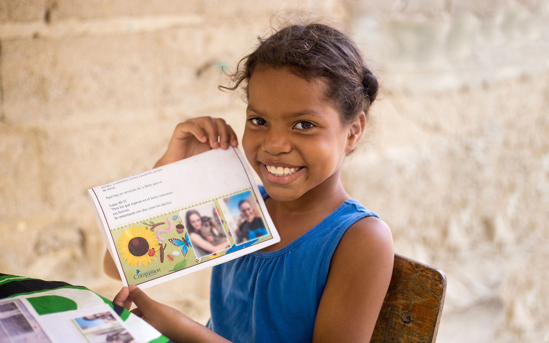 Sharith, a girl in Colombia, shows a letter from her sponsor