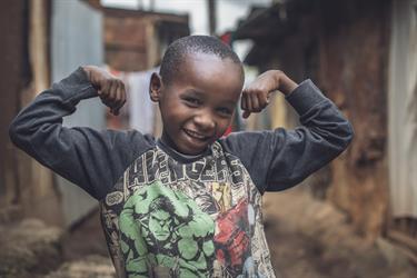 Denzel, 8, flexes his muscles to show how strong he’s growing