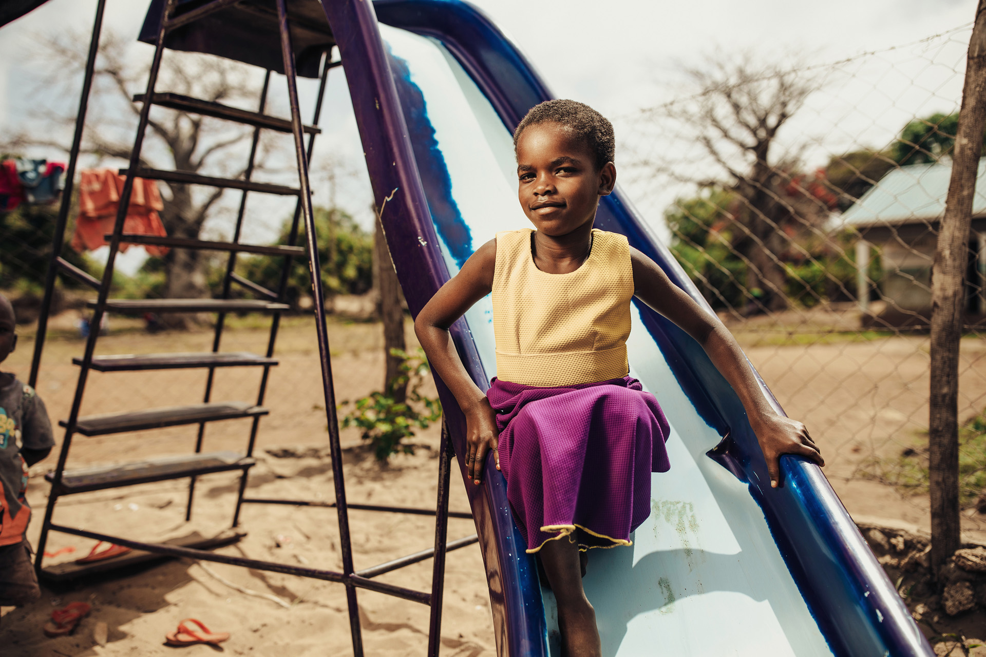 Jessica, 8, plays on the slide at her Compassion center in Kenya