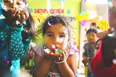 Children in Peru celebrate with confetti