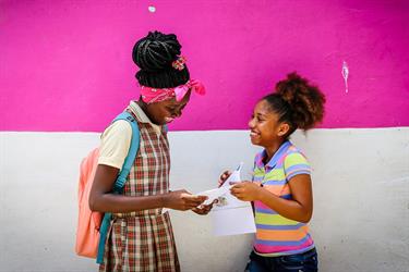 girls in Colombia read letters from their sponsors