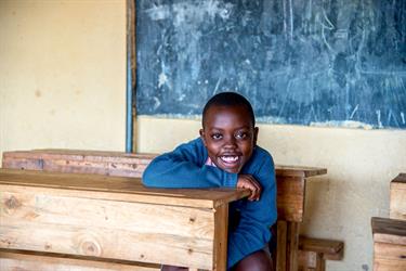 Steven sits in his classroom in Rwanda