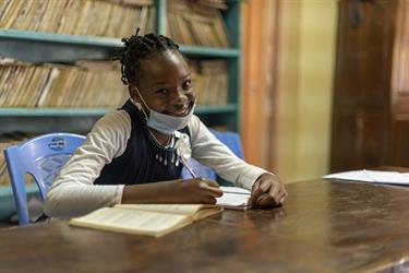 Mitchele, an eighth-grader in Kenya, sits in her classroom