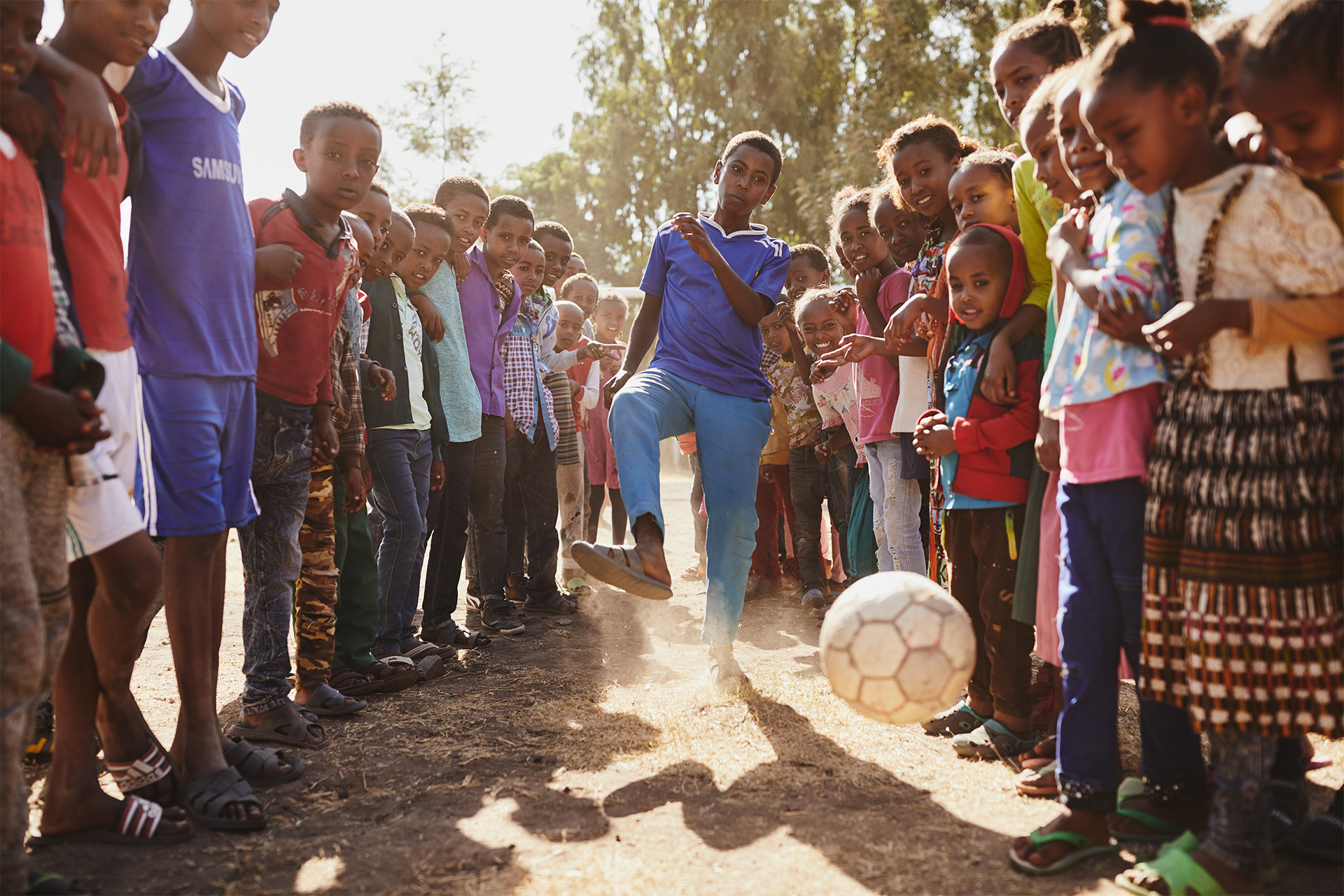 Bayisa plays soccer with other children in his Compassion center
