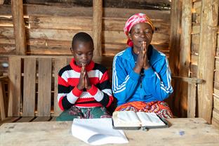 Siphora prays with her mother