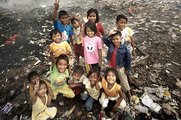 Chidren gathered together in the local city dump