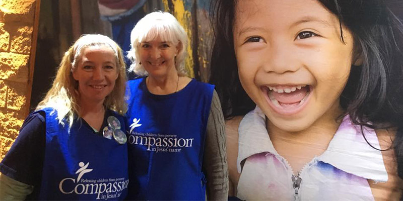 Two woman volunteers smiling