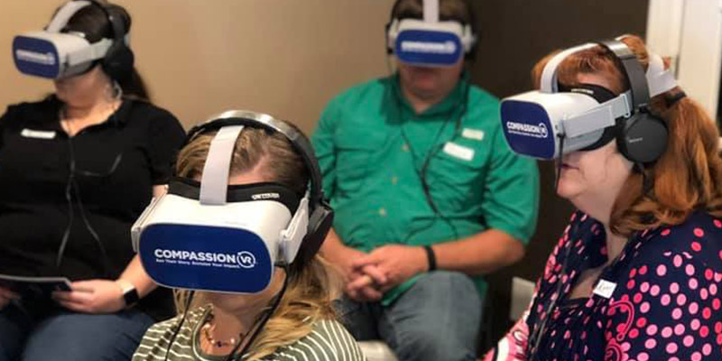 People using the Compassion VR goggles
