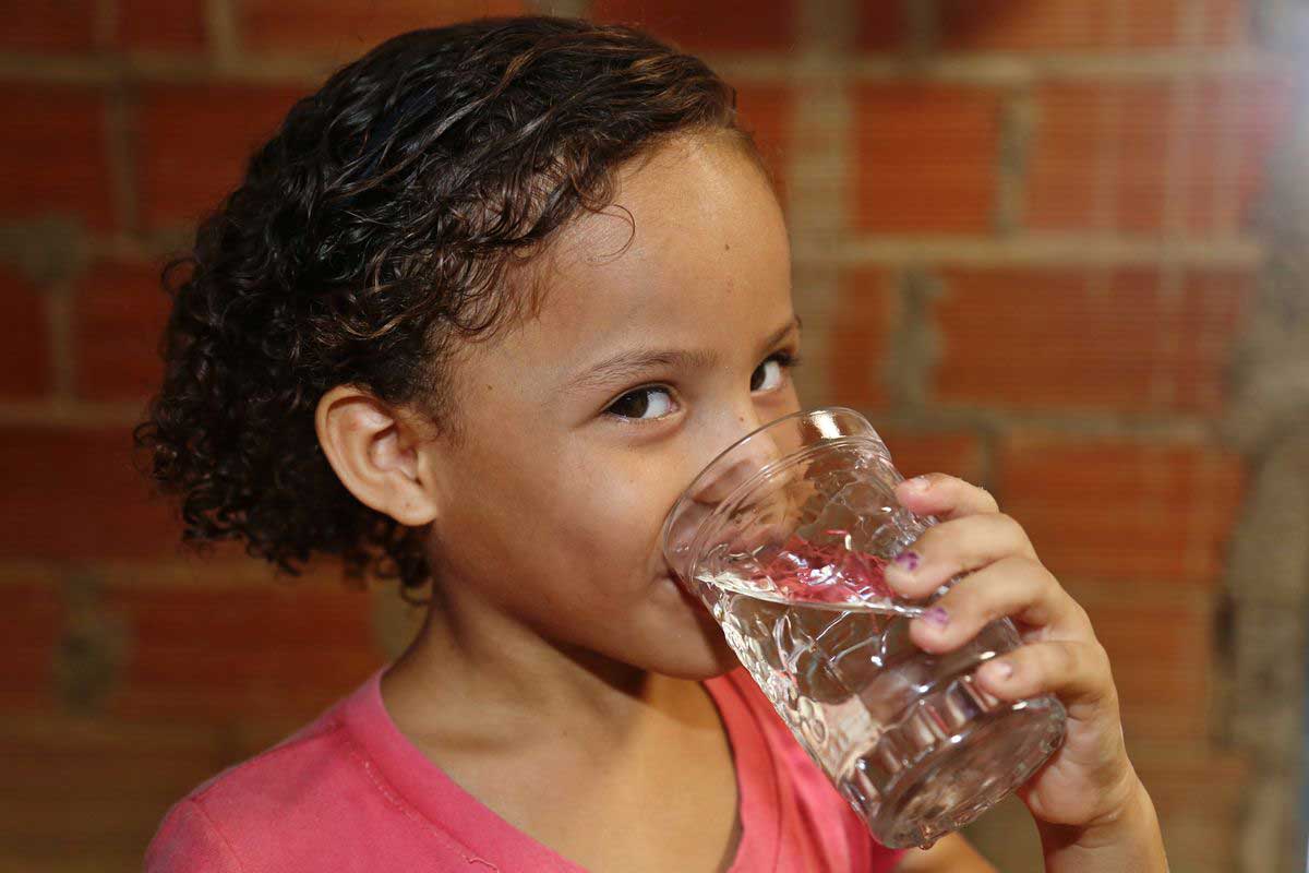 A girl drinking a glass of clean water