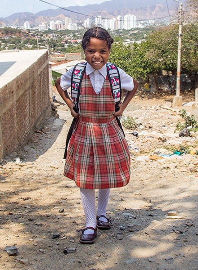 Sharith stands in her school uniform