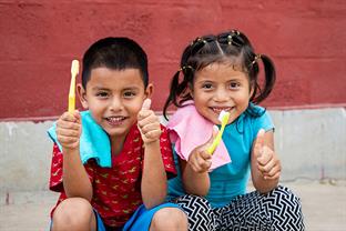 kids show off their new toothbrushes