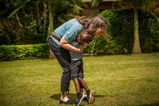 A woman hugs a child