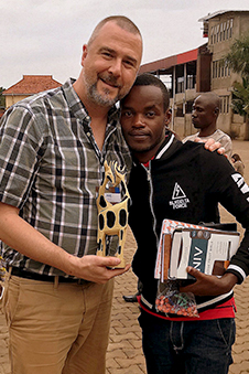 Mike standing with one of his sponsored children from Uganda