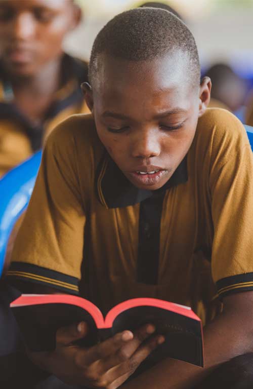 A boy reading the bible in Tanzania