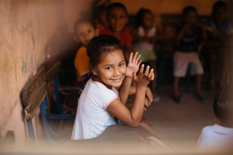 A girl sitting with other children in Nicaragua