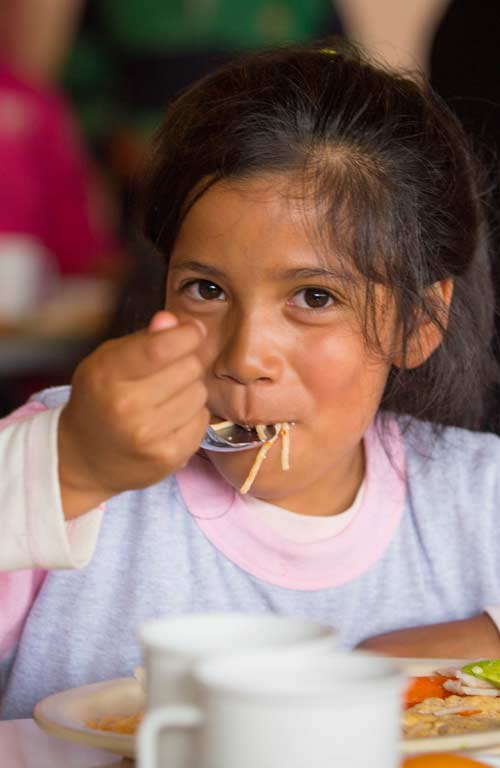 A girl enjoying a meal in Mexico