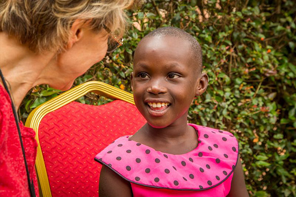 A woman talks with a sponsored child