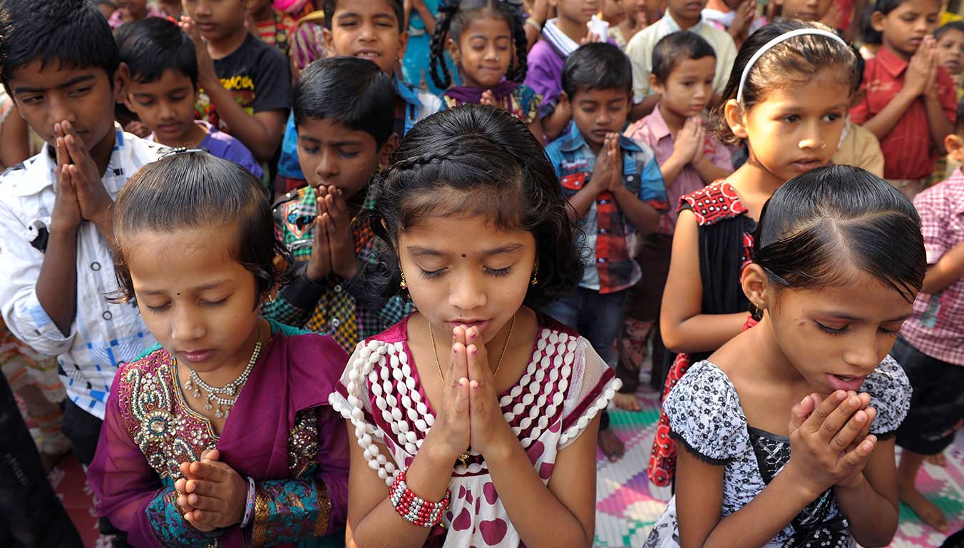 Children praying together in India