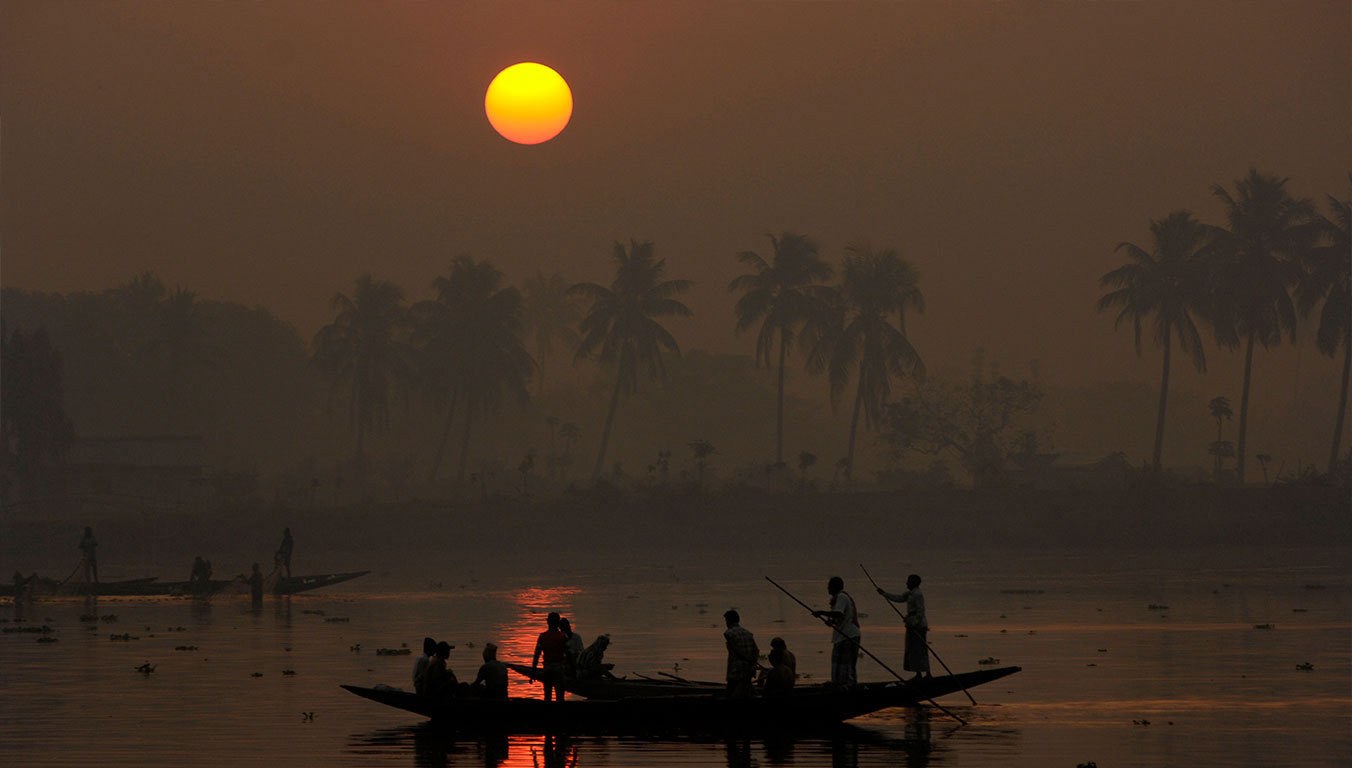 Fishing boats on the water at sunset in India