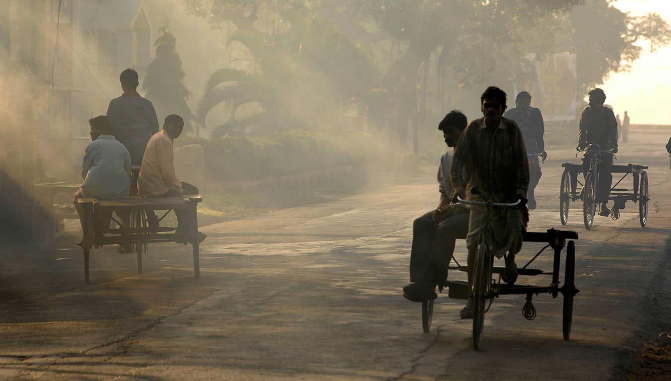 Men riding bicycles on the streets of India