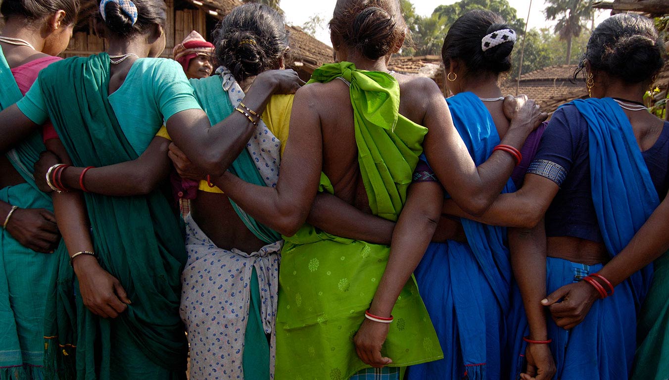 A group of women in India supporting each other with arms around one another