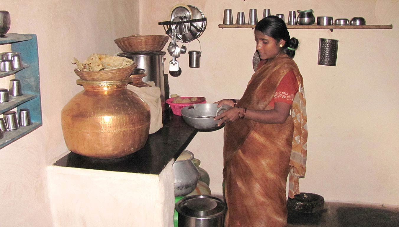 A pregnant woman preparing a meal in her home