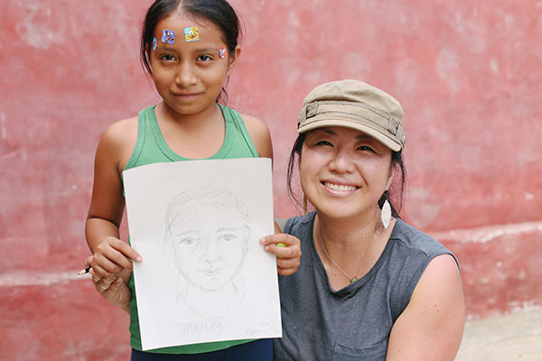 A sponsor smiles with a child