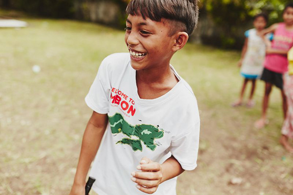 Boy playing and smiling outside