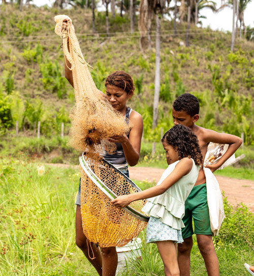 A mother and two kids prepare a net for fishing