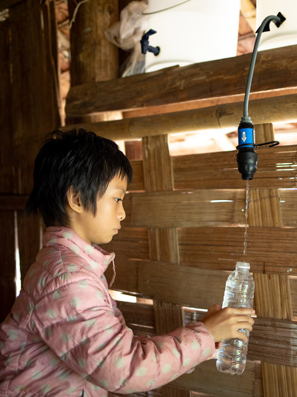 A child fills a water bottle