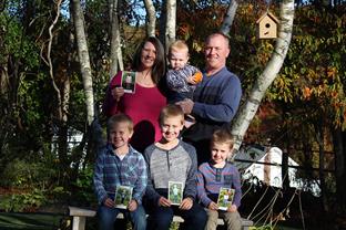 Cyndi and Scott with their sons and photos of the children they sponsor through Compassion