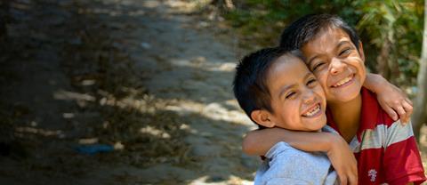 Two children hugging and smiling