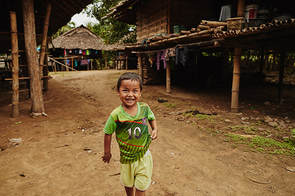 A small child running and smiling outside