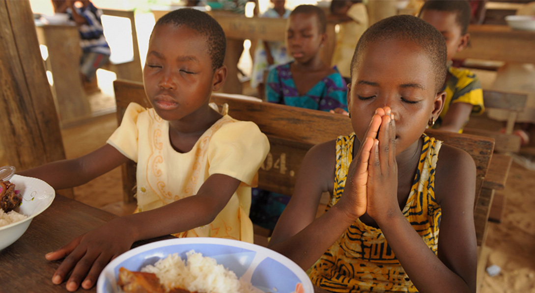 Kids praying over food